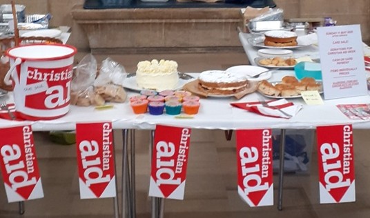 A picture of the cake sale stand with Christian Aid bunting