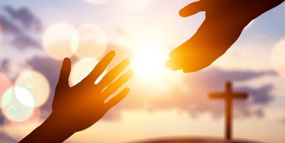 Hands reaching each other with landscape at the back
