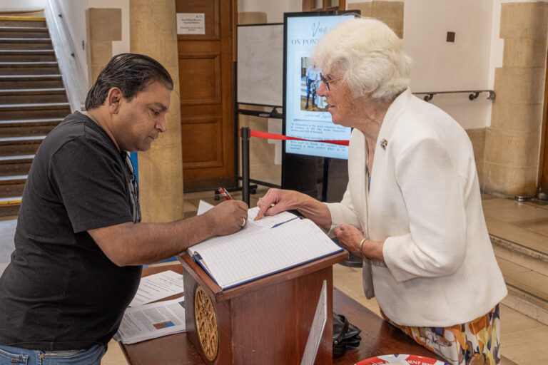 Signing the visitors book
